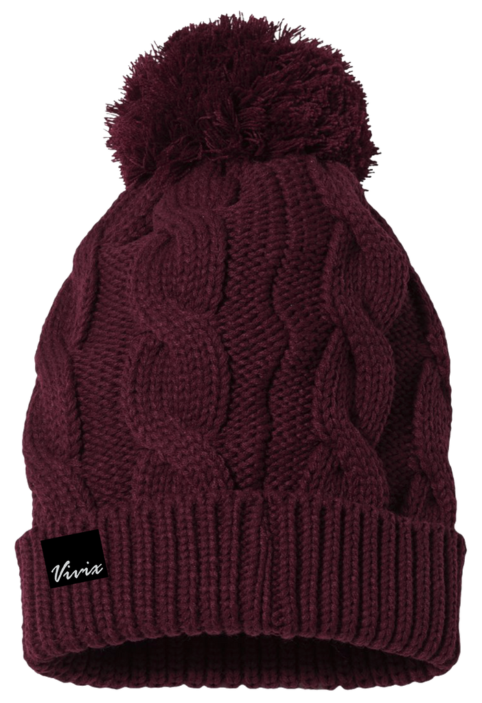 Unisex knitted beanie with a fuzzy pom pom on top